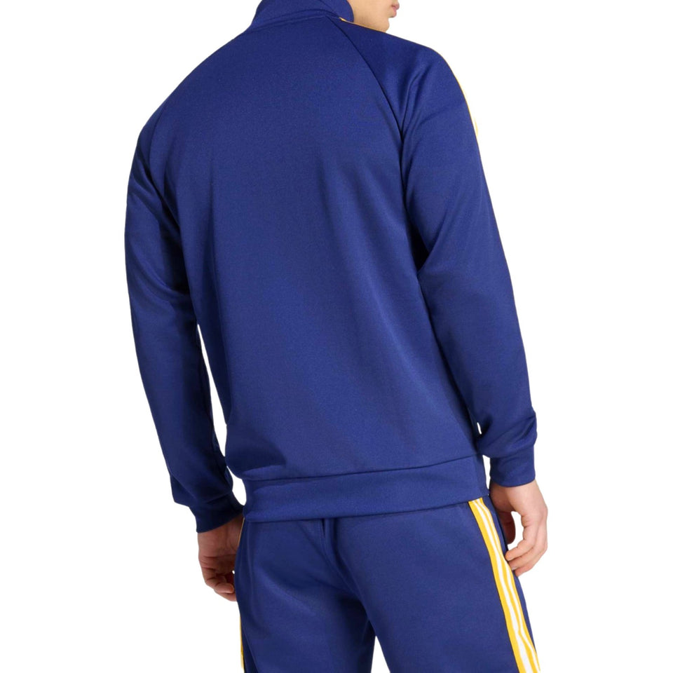 Blue Adidas Originals x Real Madrid tracksuit with yellow stripes on a white background