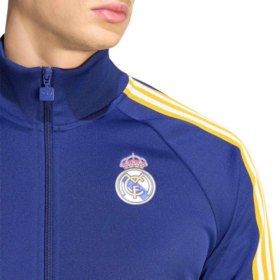 Blue tracksuit with yellow stripes and Real Madrid logo on a white background