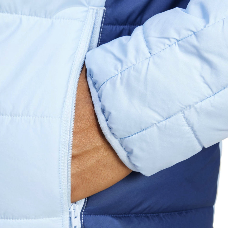 Close-up of the sleeve detail on a Real Madrid padded bench jacket 2024 in blue and light blue
