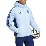 Real Madrid padded bench jacket 2024 in light blue, featuring zippered pockets and sporty design
