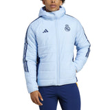 Real Madrid padded bench jacket 2024 in light blue with iconic club logo and warm design