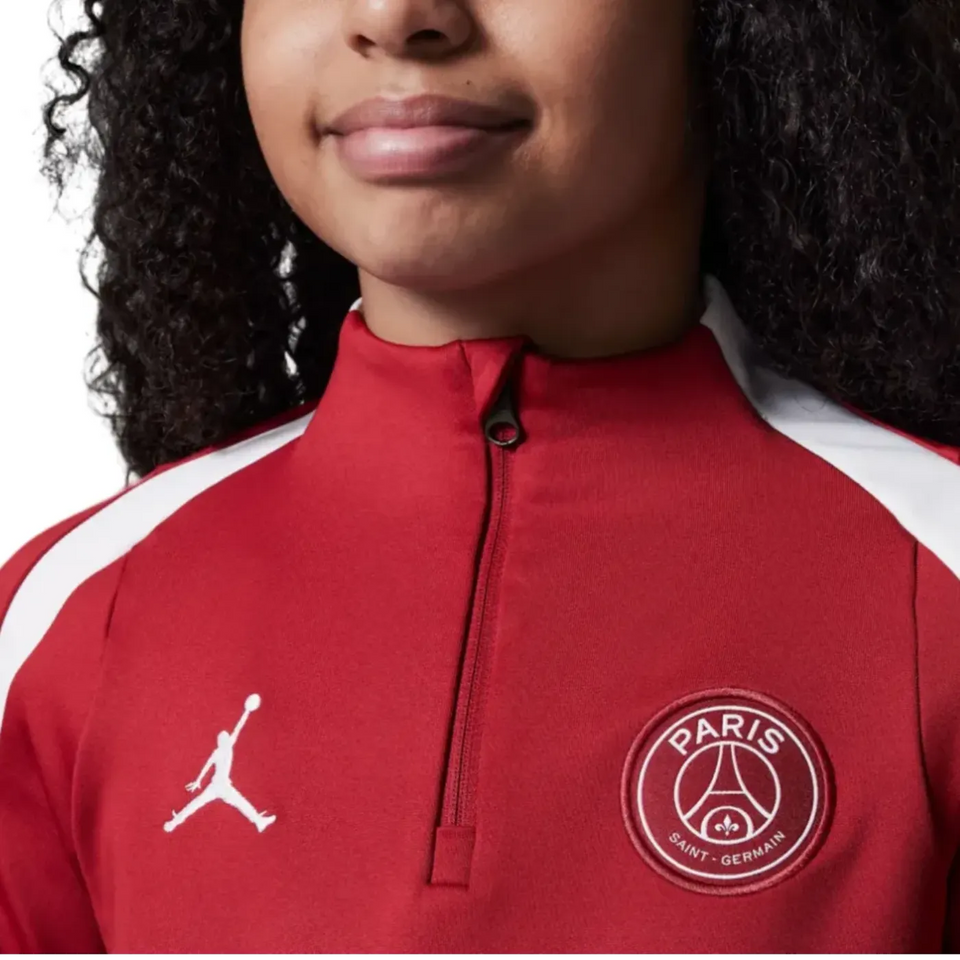 Red Jordan PSG training tracksuit for kids featuring Paris Saint-Germain logo on SoccerTracksuits.com