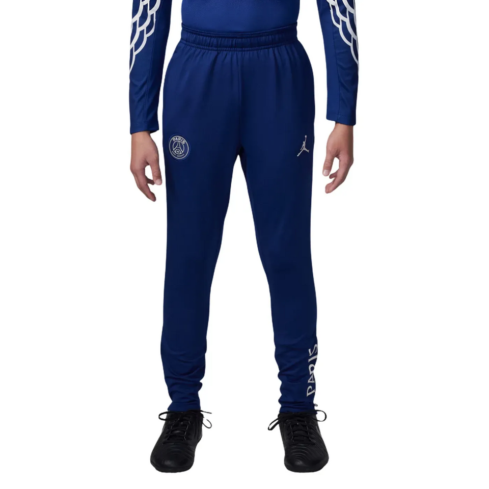 Youth wearing a blue red Jordan PSG training tracksuit for kids with logo details and comfortable fit.