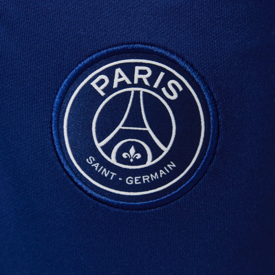 Close-up of the Paris Saint-Germain logo on a red Jordan PSG training tracksuit for kids