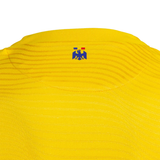 Back view of Romania national team jersey Joma in bright yellow with emblem detail