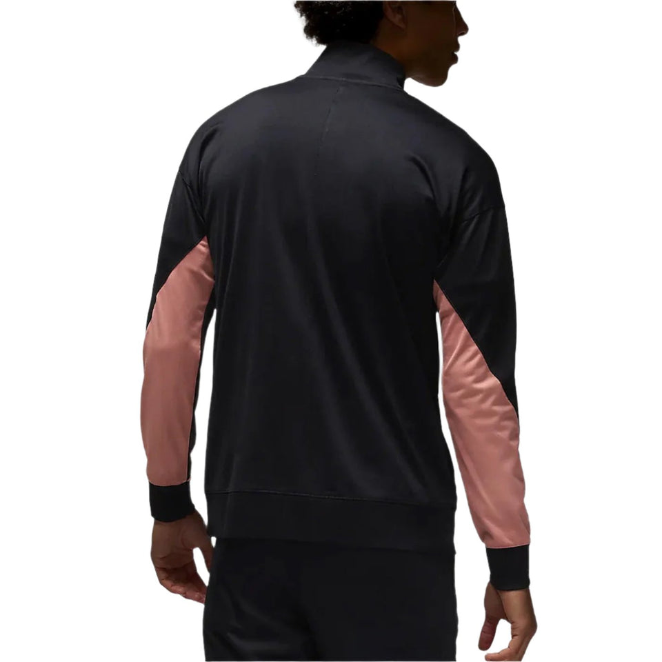 Back view of man wearing black and pink PSG Champions League tracksuit jacket with long sleeves