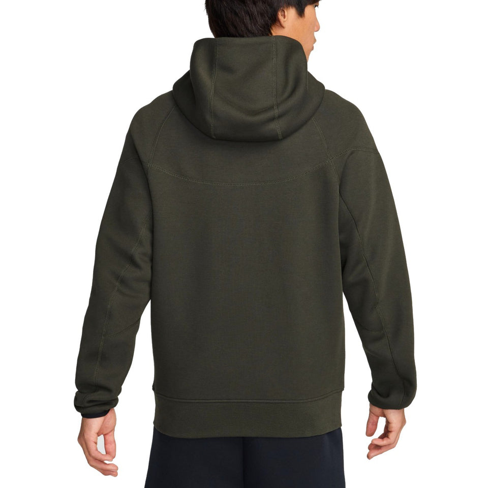 Back view of man wearing dark green Tottenham Hotspur Nike Tech Fleece tracksuit hoodie