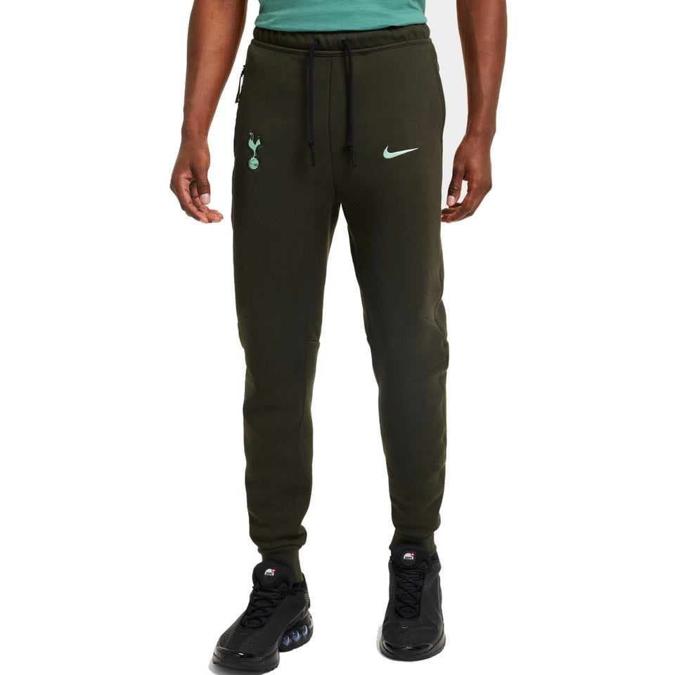 Men wearing dark green Tottenham Hotspur Nike Tech Fleece tracksuit pants with drawstring waist