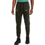Men wearing dark green Tottenham Hotspur Nike Tech Fleece tracksuit pants with drawstring waist