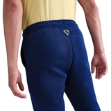 Back view of navy Nike tracksuit bottoms featuring Tottenham Hotspur UCL Tech Fleece design for comfort