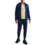 Model wearing Tottenham Hotspur UCL Tech Fleece tracksuit in navy with logo on SoccerTracksuits.com
