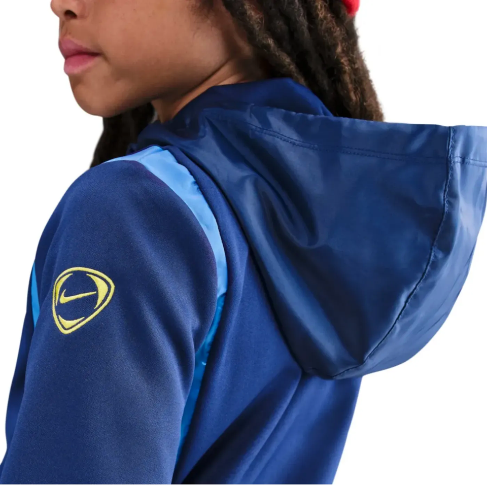 Close-up of a child wearing a Tottenham Hotspur youth tracksuit 2025 26 with a hood and vibrant detailing