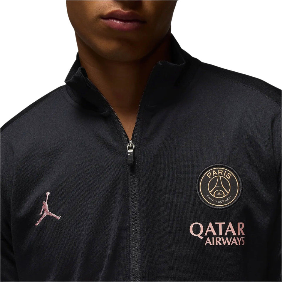 Close-up of black PSG Champions League tracksuit jacket with Paris Saint-Germain and Qatar Airways logos