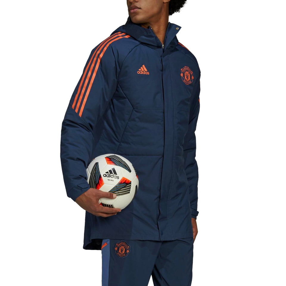 Manchester United bench parka jacket 2022 in navy with orange stripes and logo, perfect for soccer fans