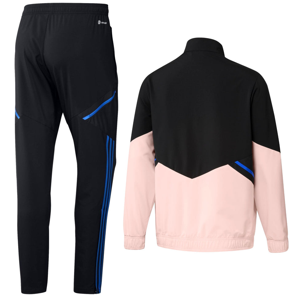 Adidas Manchester United presentation tracksuit featuring black and pink design with blue accents