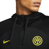 Close-up of Inter Milan Nike UCL tracksuit 2022 23 logo and hood detail in black with yellow accents