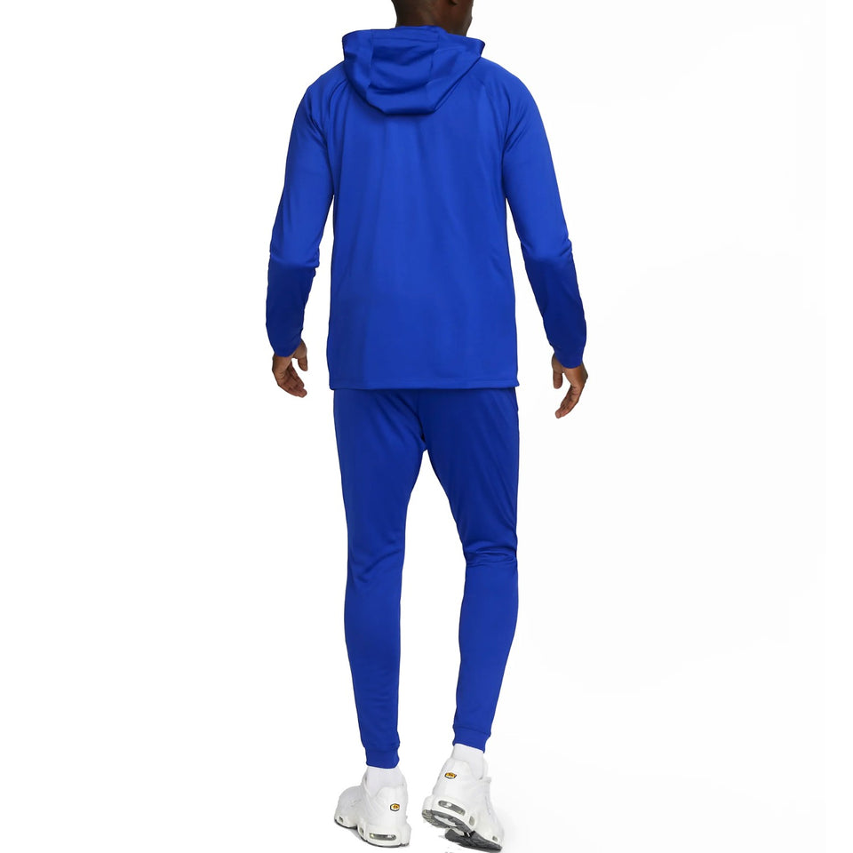 Back view of man wearing blue Nike PSG soccer tracksuit with hood and slim fit pants buy Nike PSG soccer tracksuit online