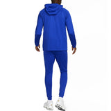Back view of man wearing blue Nike PSG soccer tracksuit with hood and slim fit pants buy Nike PSG soccer tracksuit online
