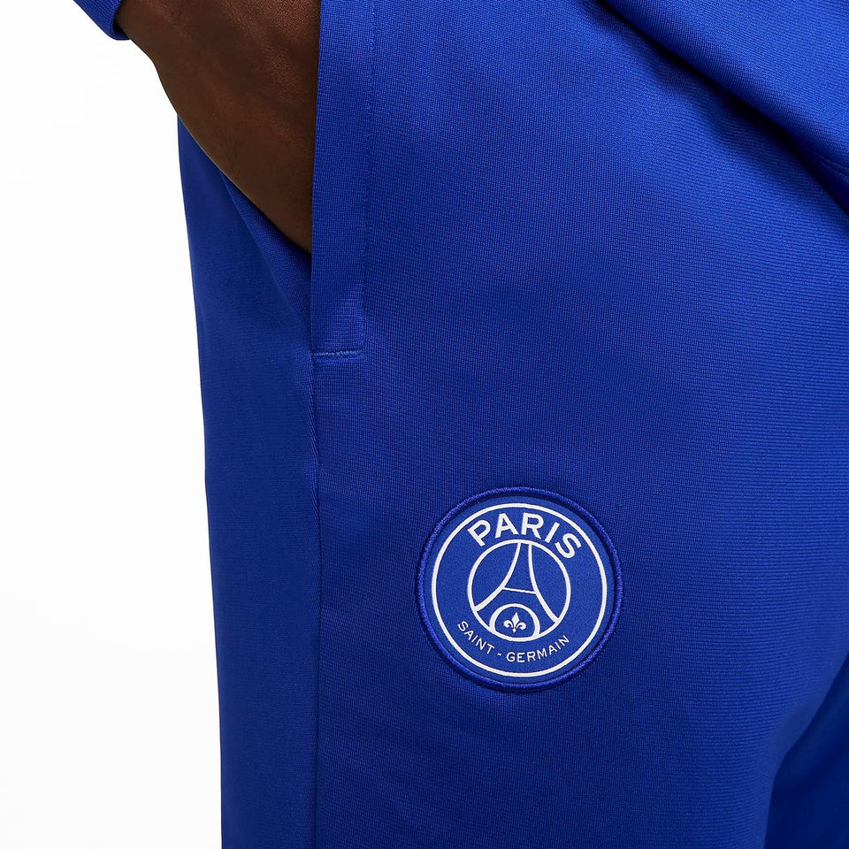 Close-up of blue Nike PSG soccer tracksuit with Paris Saint-Germain logo pocket to buy Nike PSG soccer tracksuit online