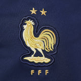 Close-up of France hooded tracksuit Nike featuring the embroidered rooster emblem on navy fabric