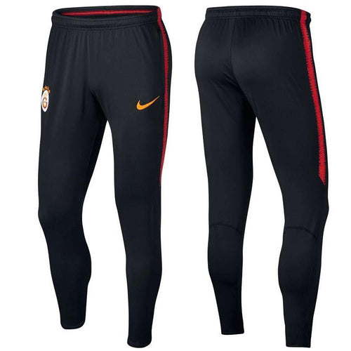 Galatasaray training pants in black with Nike logo and vibrant red accents for athletic performance