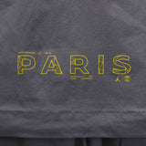 Close-up of yellow Paris graphic on grey Jordan PSG presentation suit fabric
