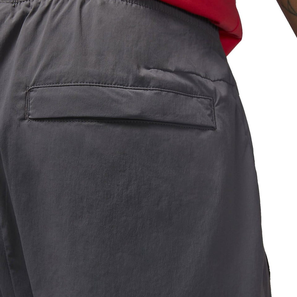 Close-up view of back pocket on grey Jordan PSG presentation suit pants by SoccerTracksuits.com