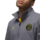 Close-up of grey Jordan PSG presentation suit jacket with Paris Saint-Germain logo and yellow Jumpman logo