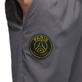 Close-up of grey Jordan PSG presentation suit pants with Paris Saint-Germain logo patch