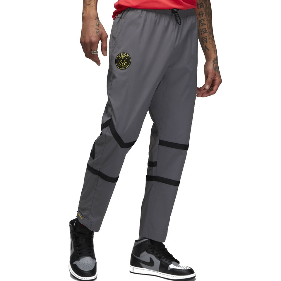 Grey Jordan PSG presentation suit pants with black stripes and PSG logo on left thigh